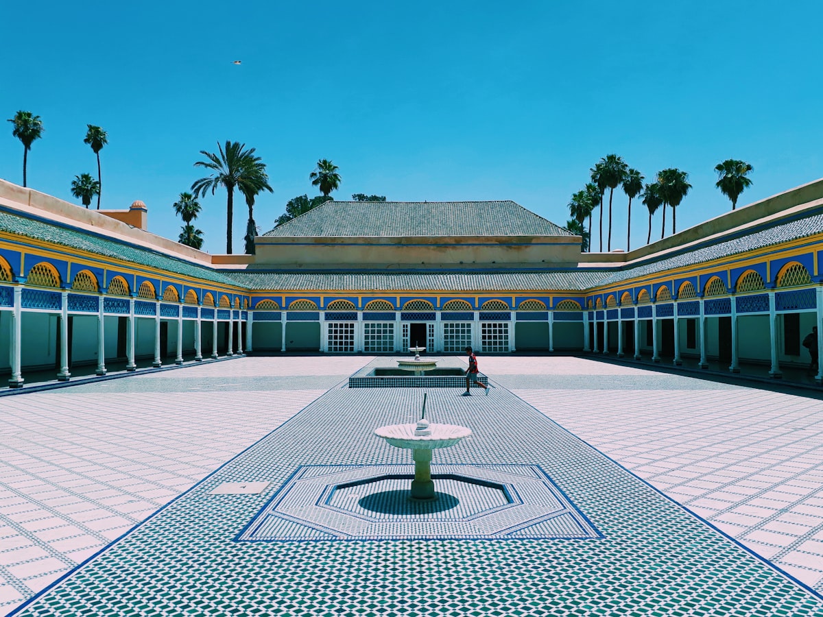 person walking near Marrakech building during daytime