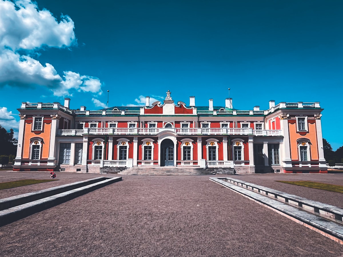 Grand palace with ornate facade and blue sky