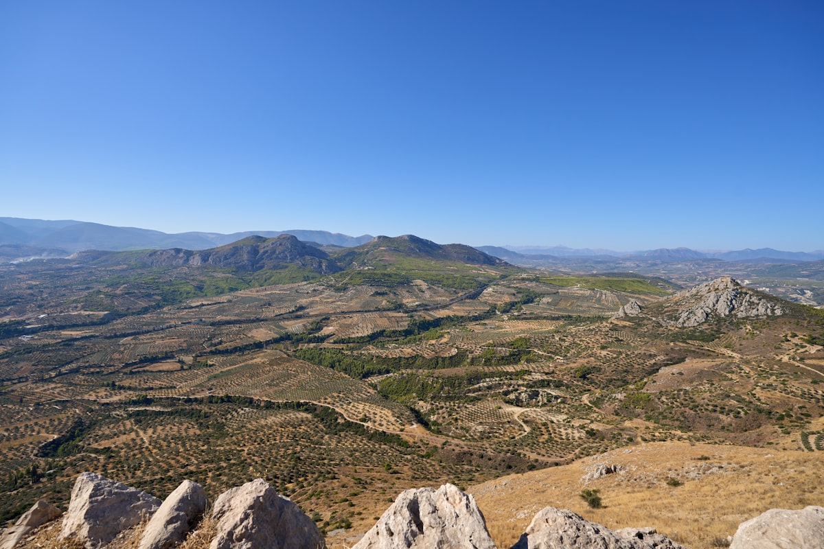 Expansive mountainous landscape under a clear blue sky.