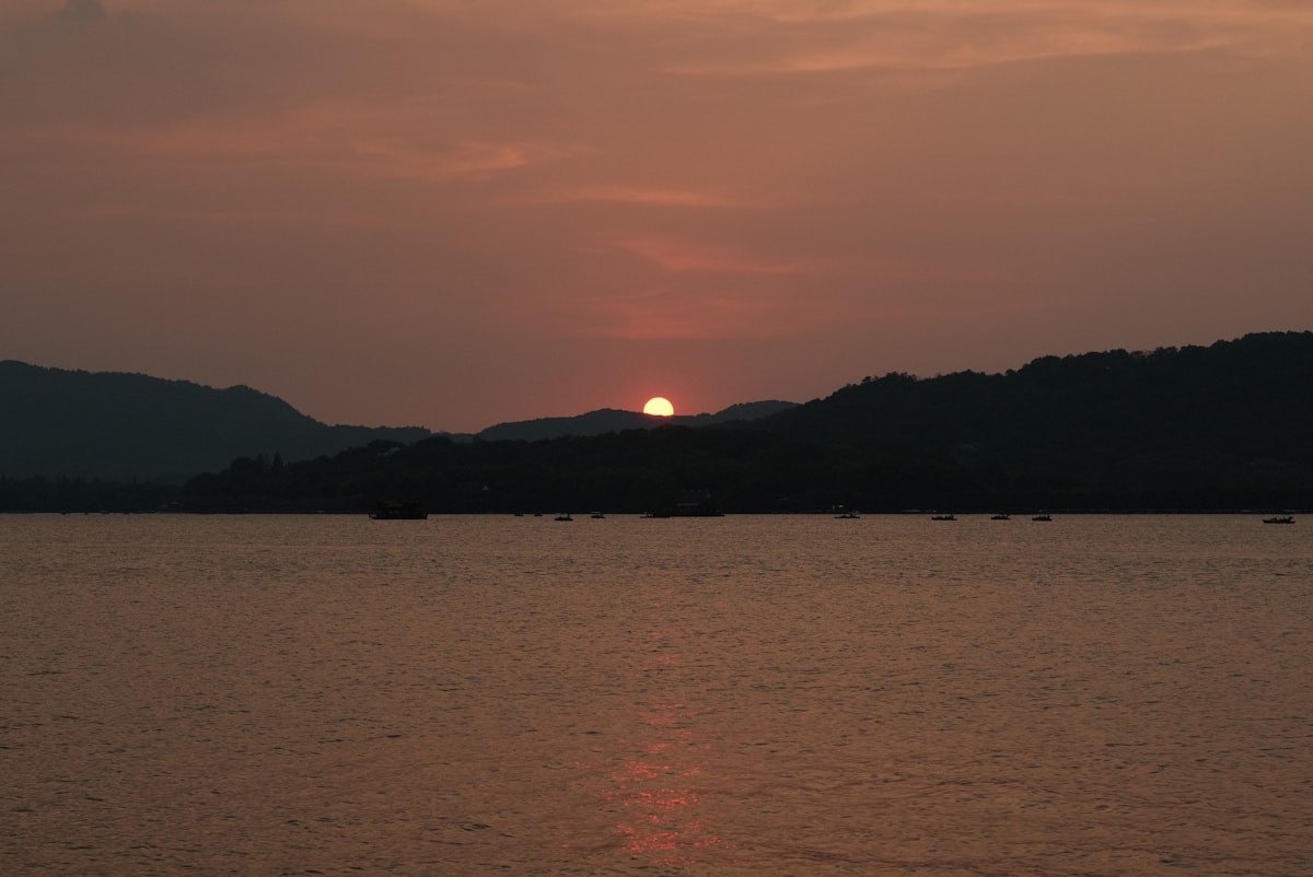 The sun is setting over a body of water