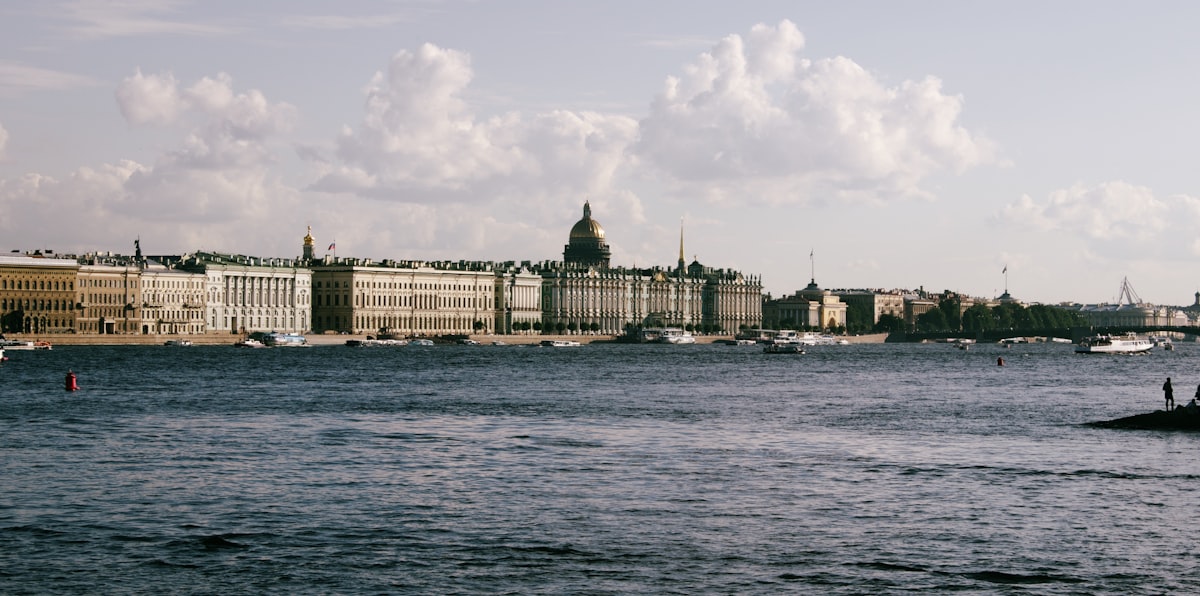 City skyline with a large dome building across the water.