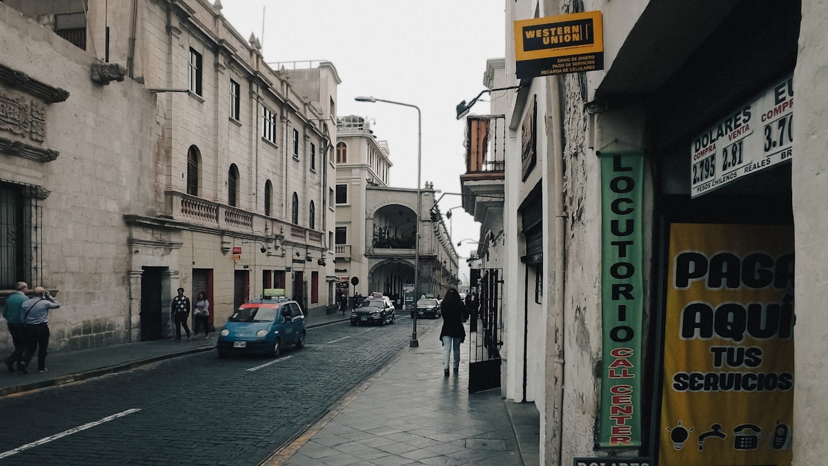 Street scene with old buildings and a car.