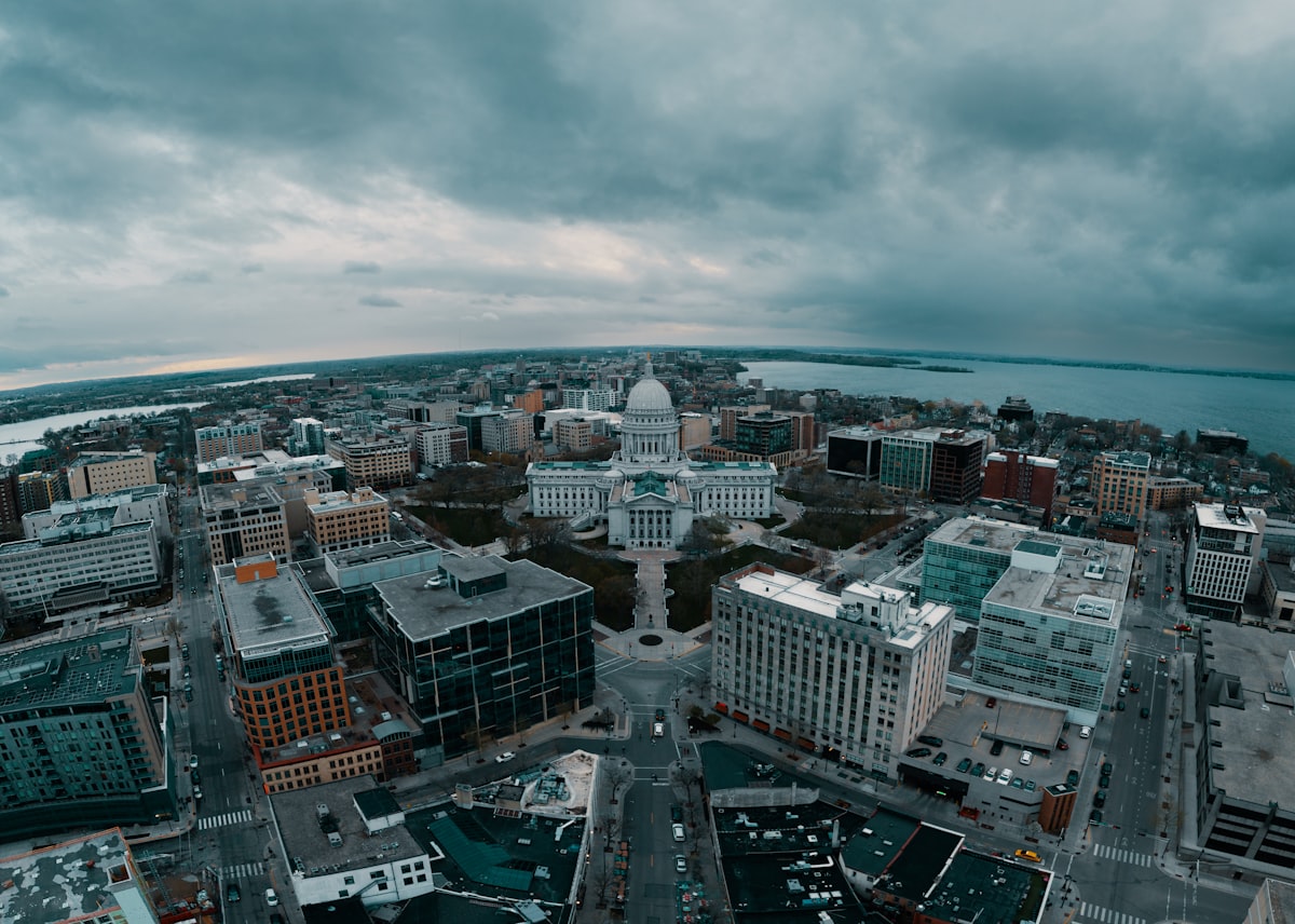 an aerial view of a city with a body of water in the background