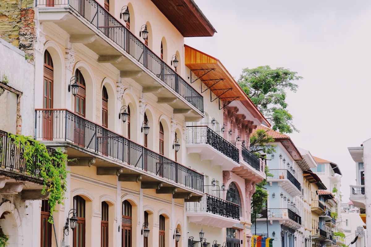 a row of buildings with balconies and trees