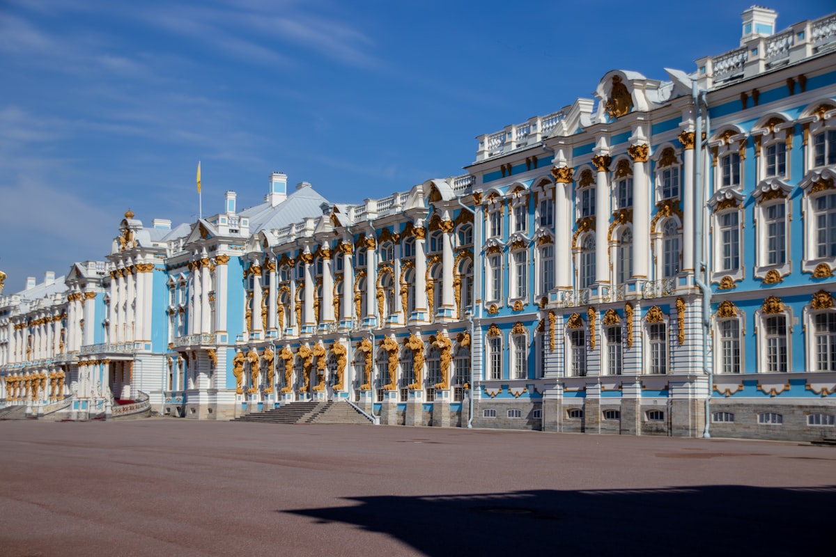 A beautiful, blue palace stands against a clear sky.