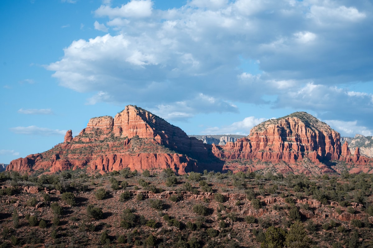 A view of a mountain range with clouds in the sky