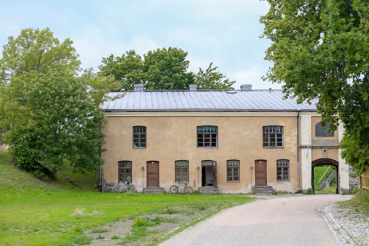 Historic stone building with arched entryway and square windows.