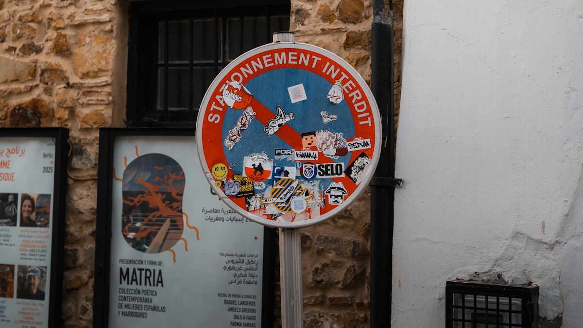 No parking sign, decorated with stickers.