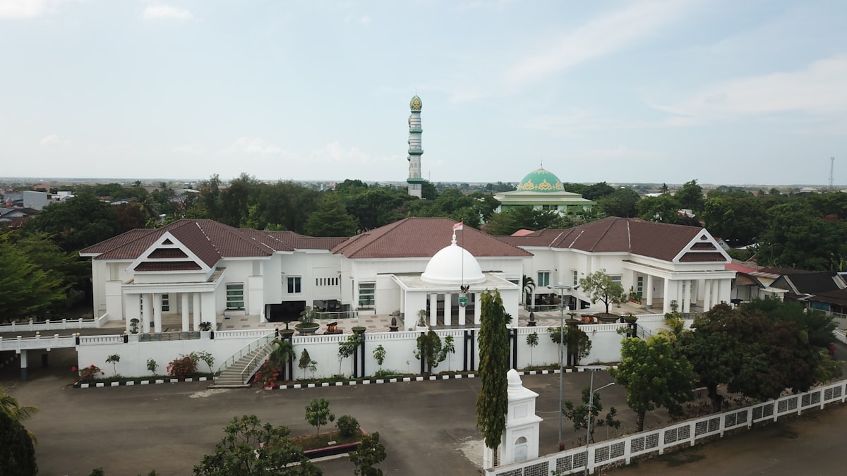 a large white building with a green dome on top of it