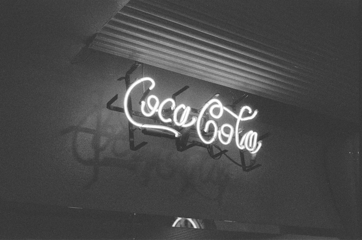A black and white photo of a neon sign