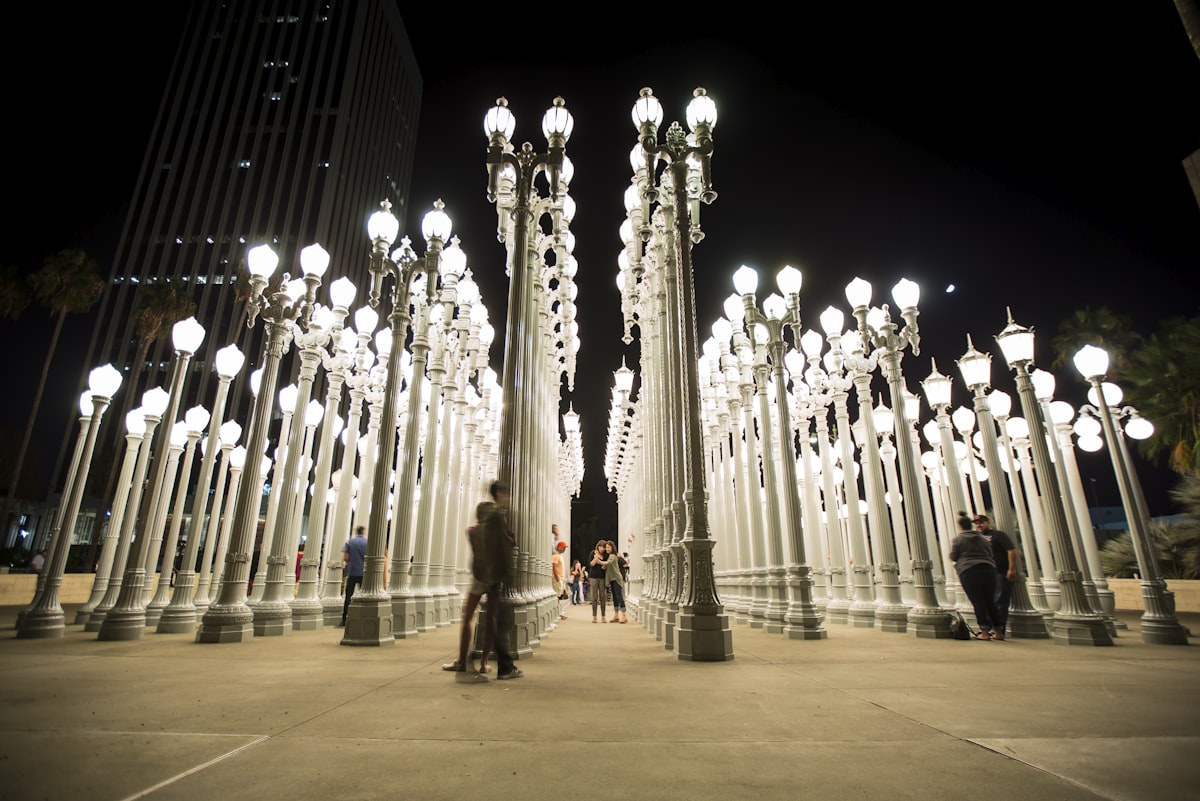 A couple of people that are standing in front of some lights