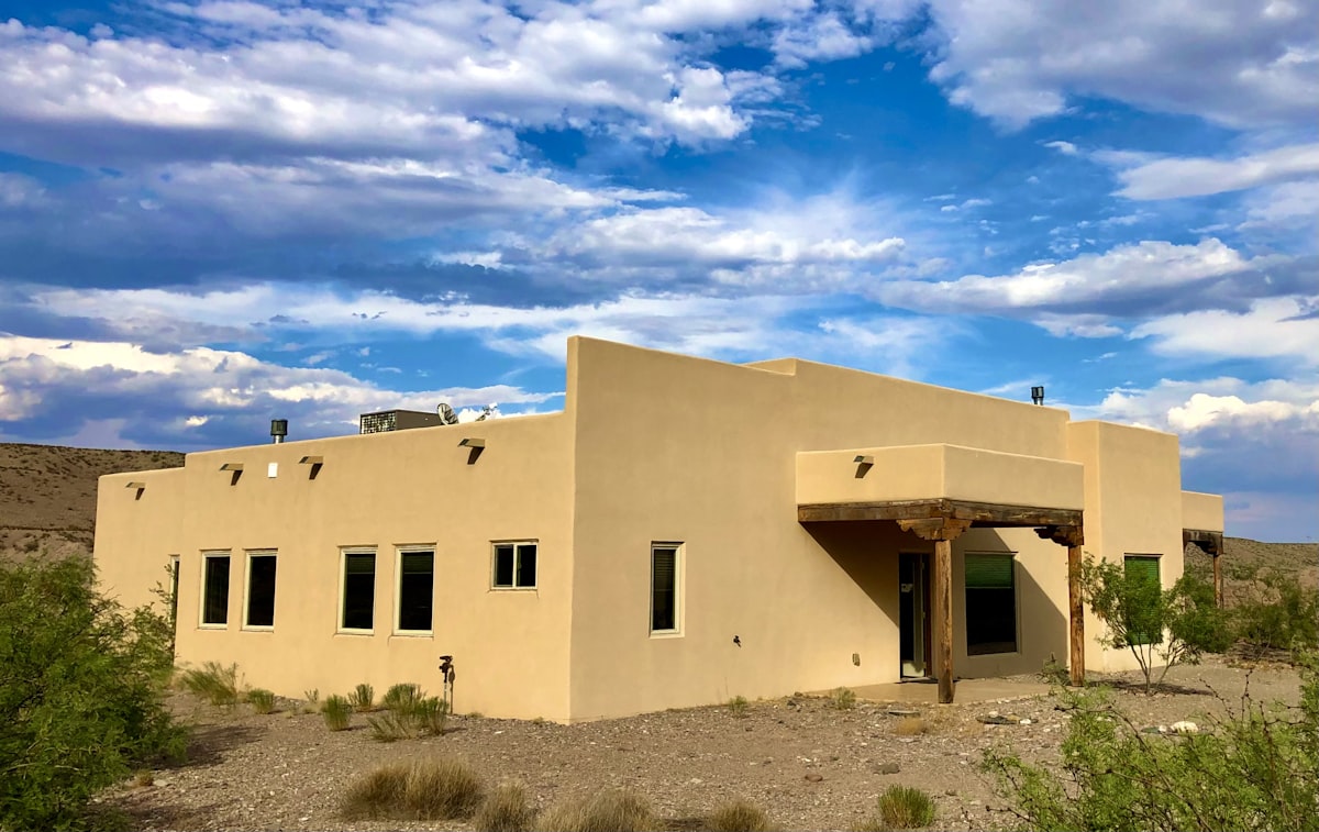 a tan building with a blue sky in the background