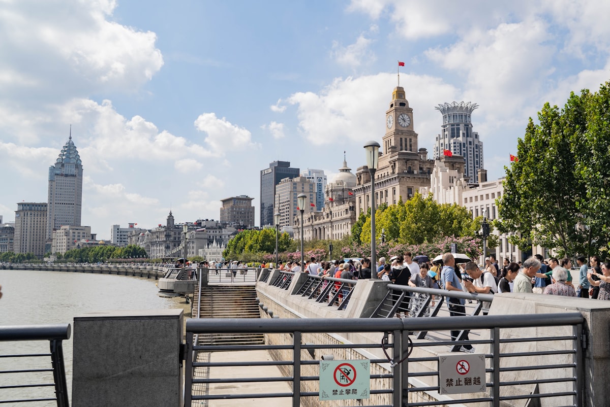 a group of people standing on a bridge over a river