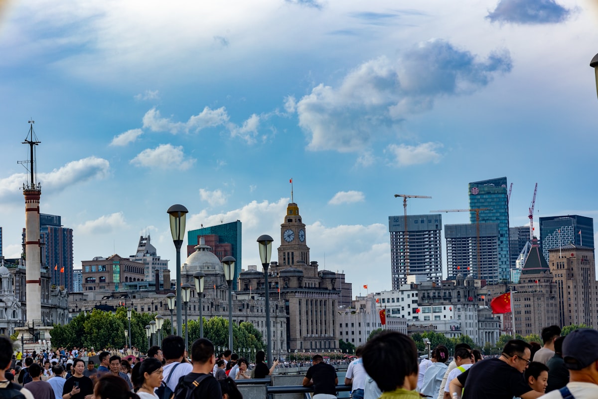 a crowd of people standing in front of tall buildings