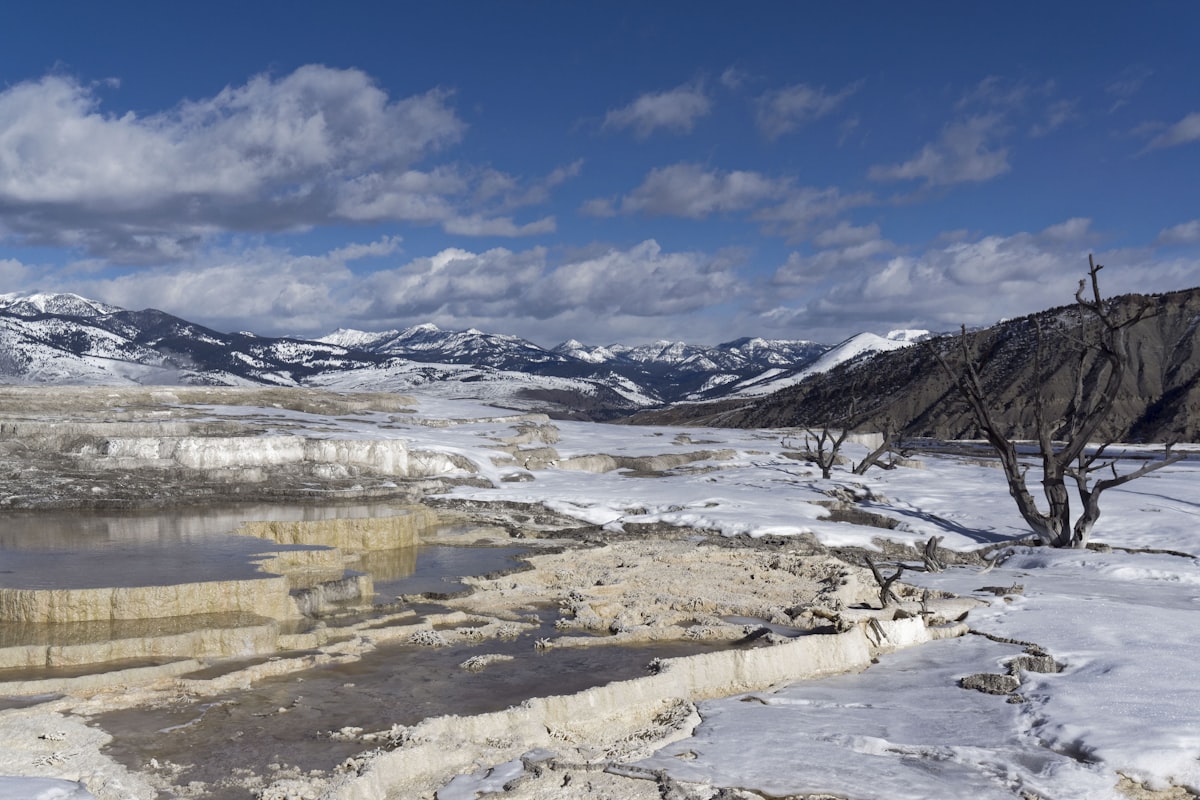 Snowy landscape with hot springs and mountains