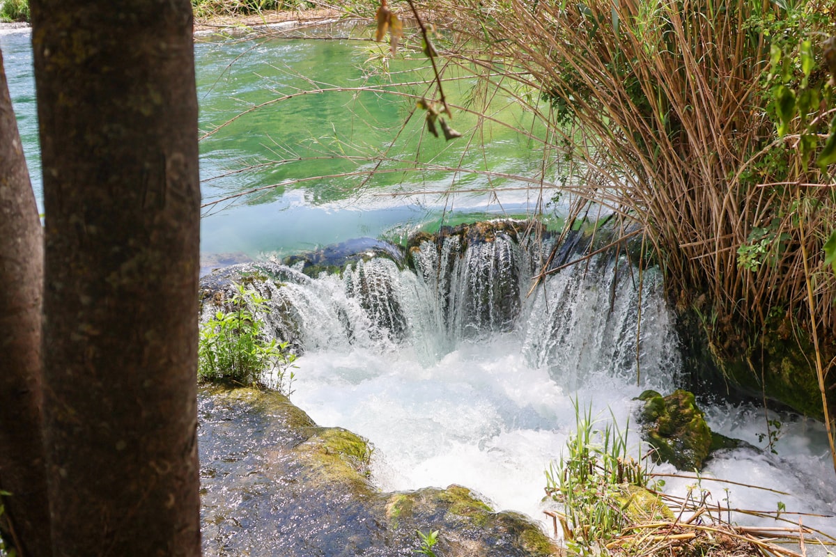 a small waterfall in the middle of a river
