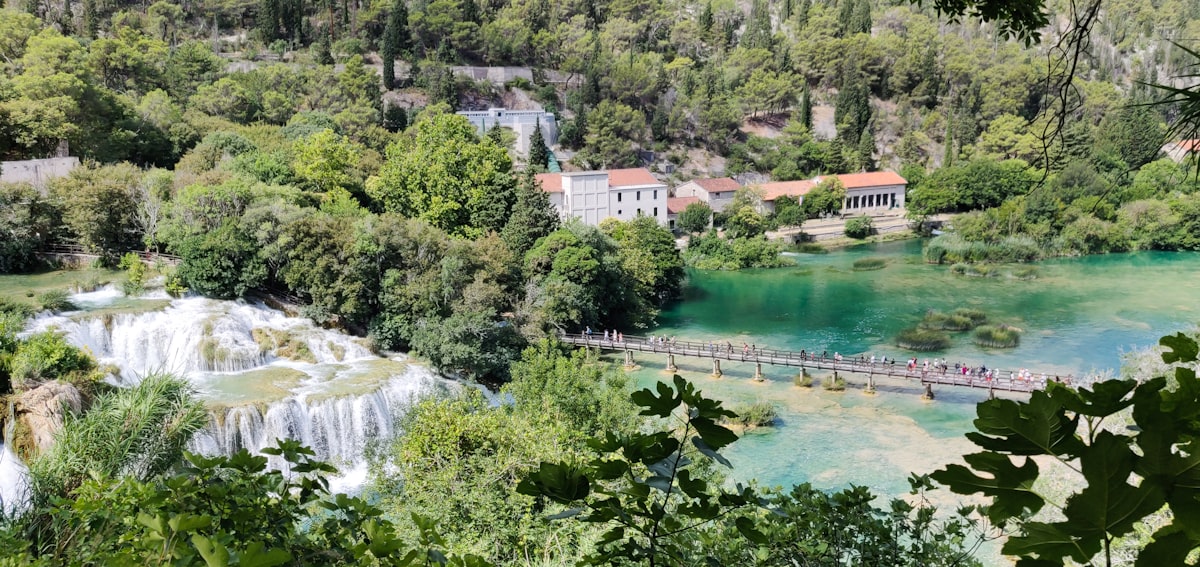 a river with a bridge and a house on the other side