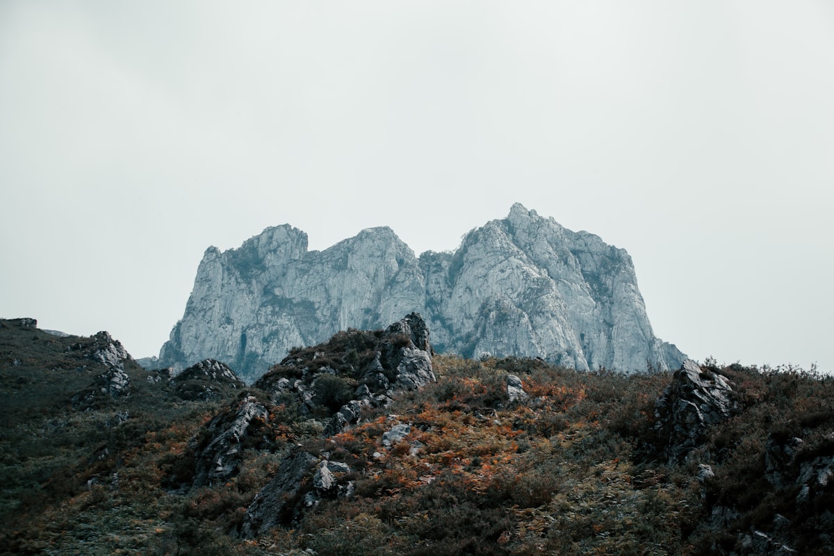 a rocky mountain with fog