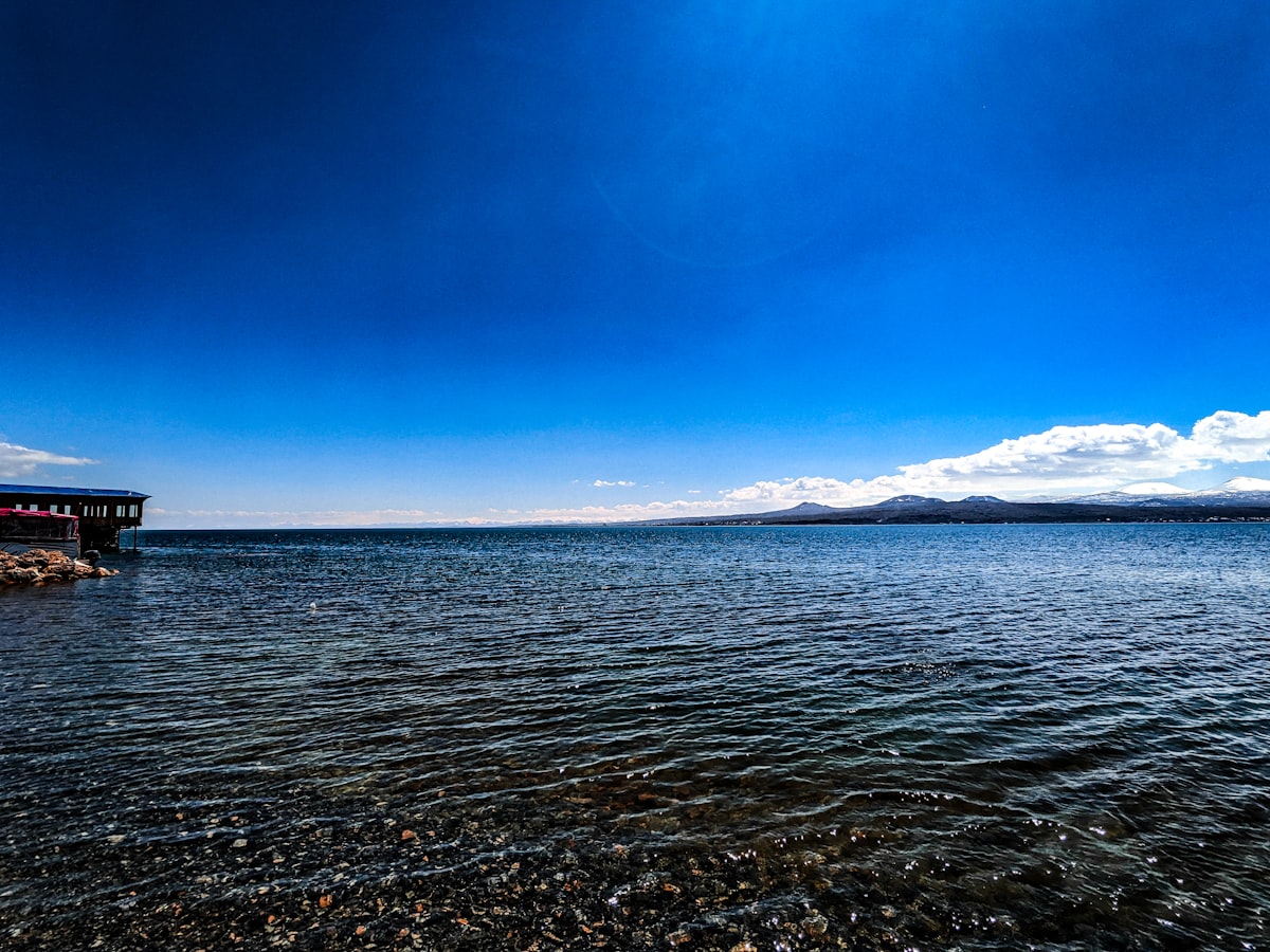 a body of water with a pier in the background