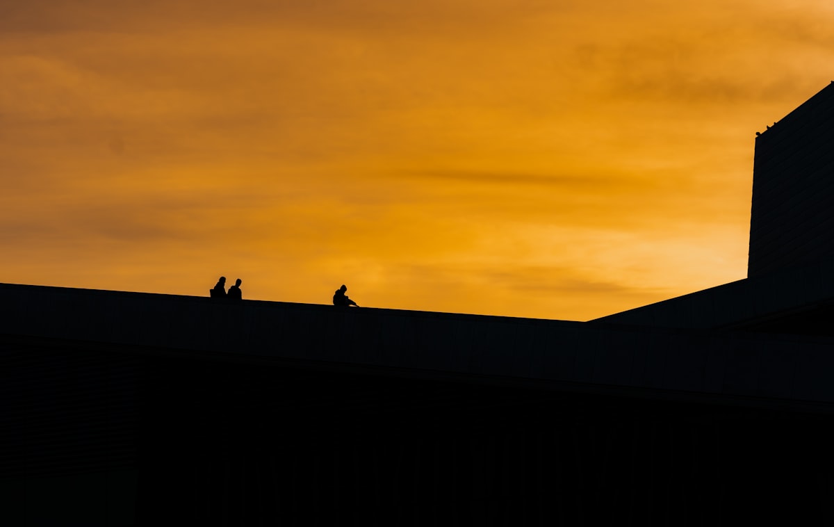 A silhouette of a building against a sunset