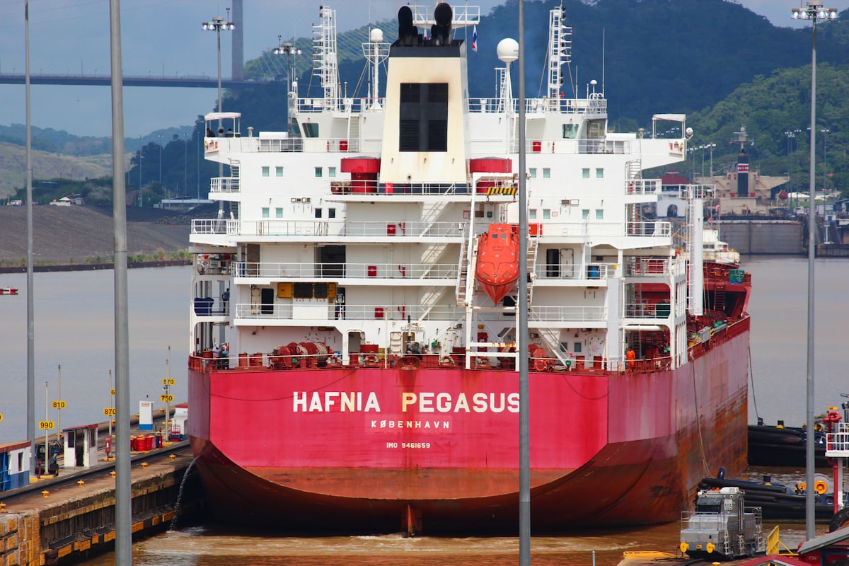 a large red and white boat docked at a dock