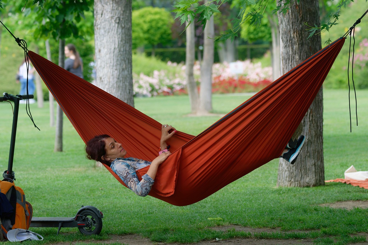 woman, relaxing, hammock, adult, red hammock, trees, park, nature, grass, electric scooter, rest