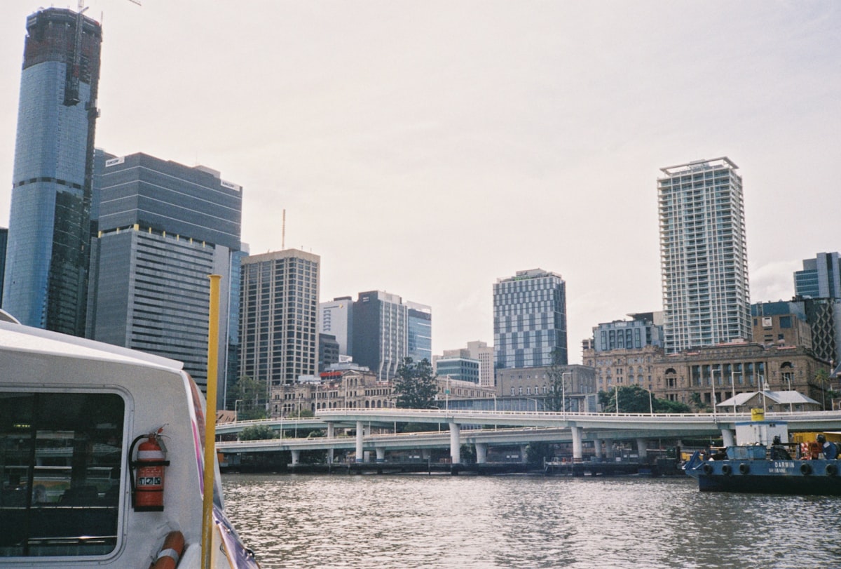white and blue high rise buildings near body of water during daytime