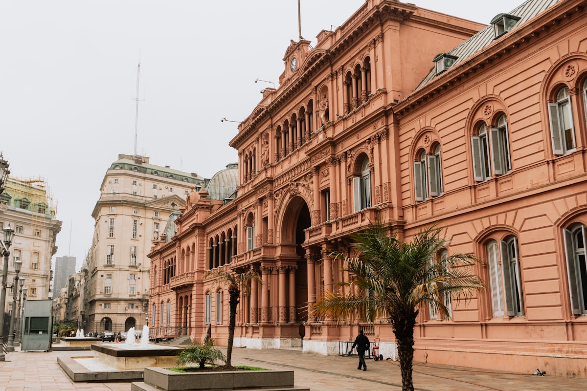 An old building with a palm tree in front of it