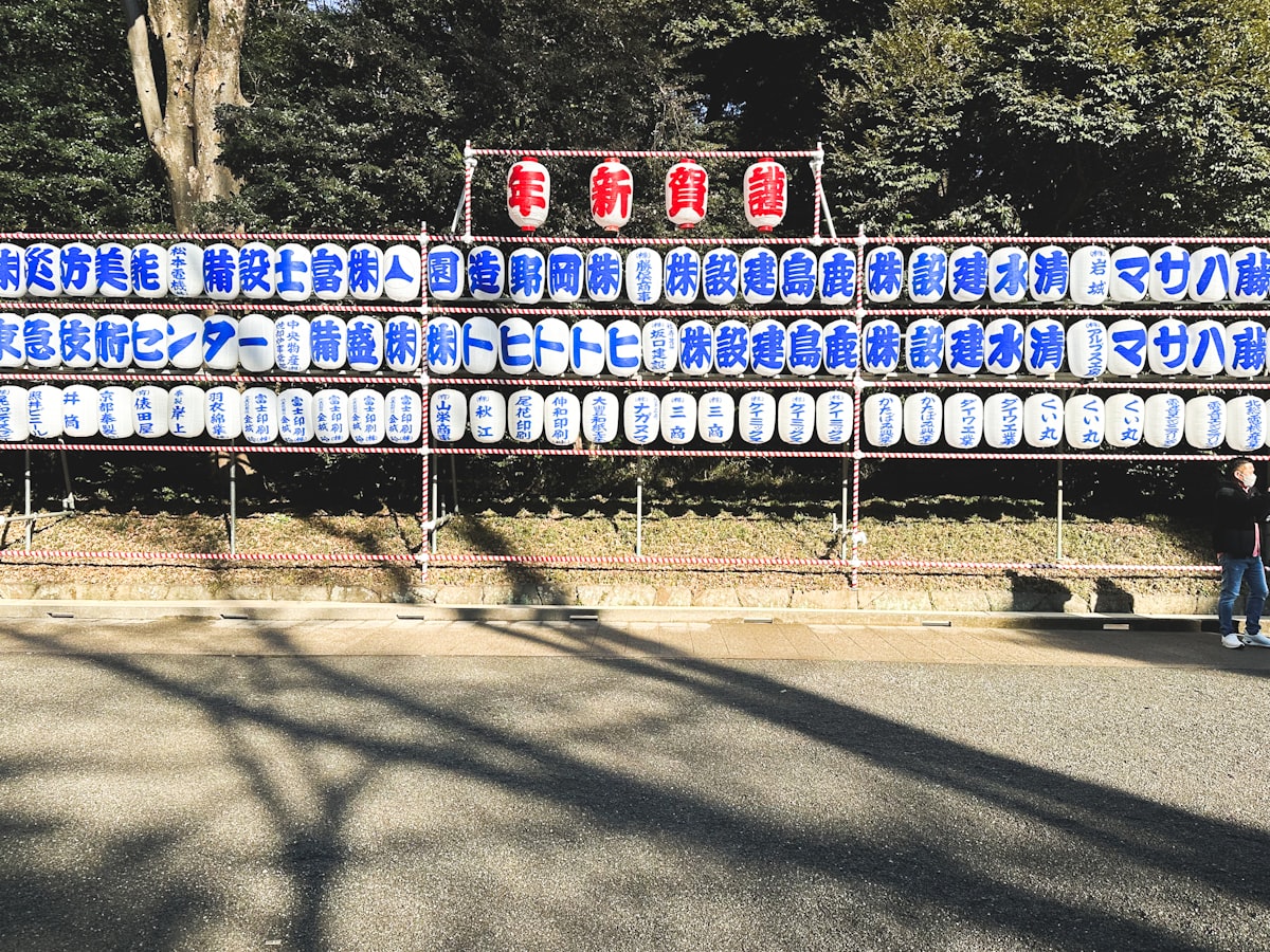 a man walking past a large display of license plates