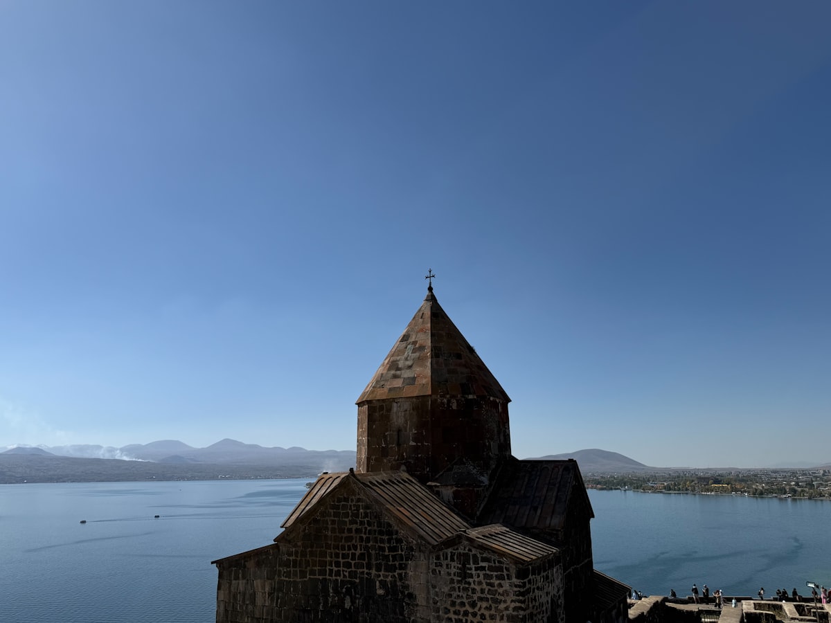 Ancient stone church overlooking a vast blue lake