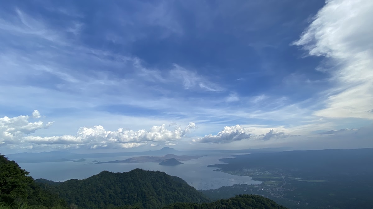 green mountains under blue sky and white clouds during daytime