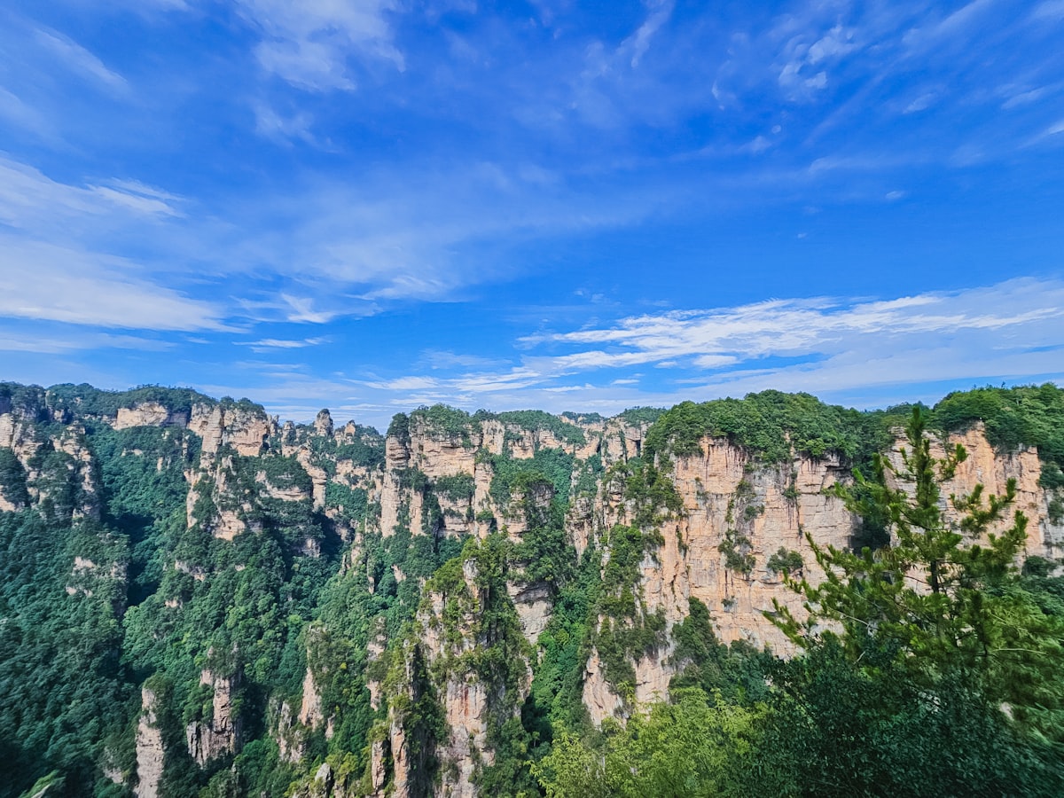 Towering green mountains under a blue sky