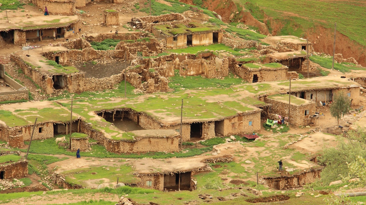an aerial view of a village in the mountains