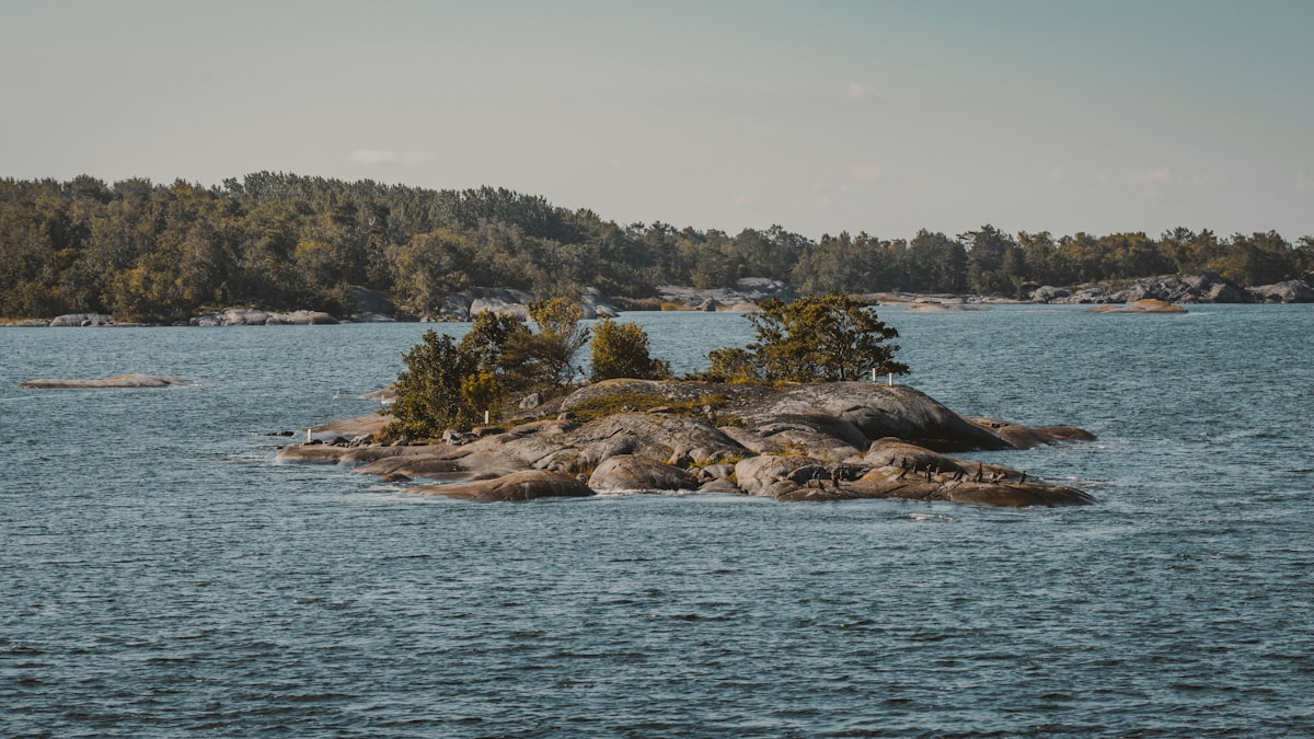 A small island in the middle of a large body of water