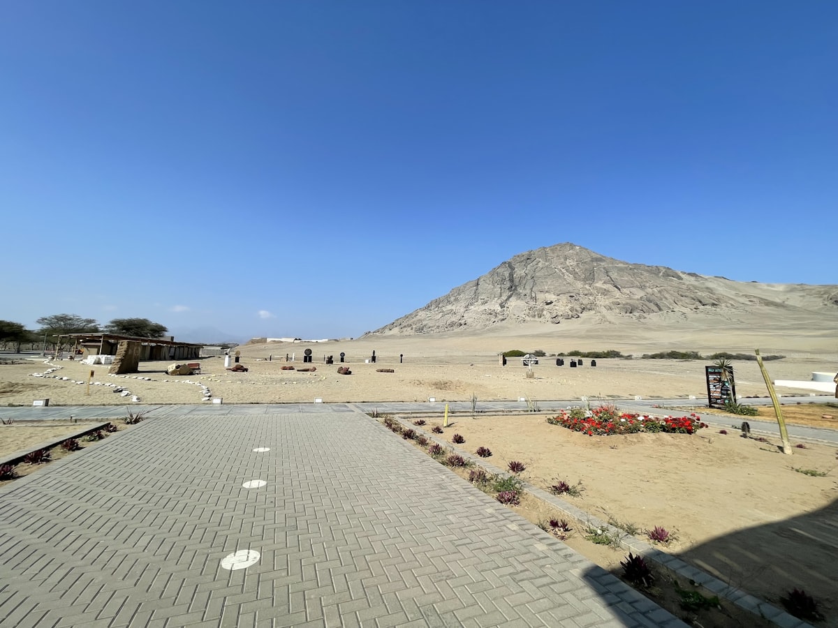 A panoramic view of a parking lot with a mountain in the background