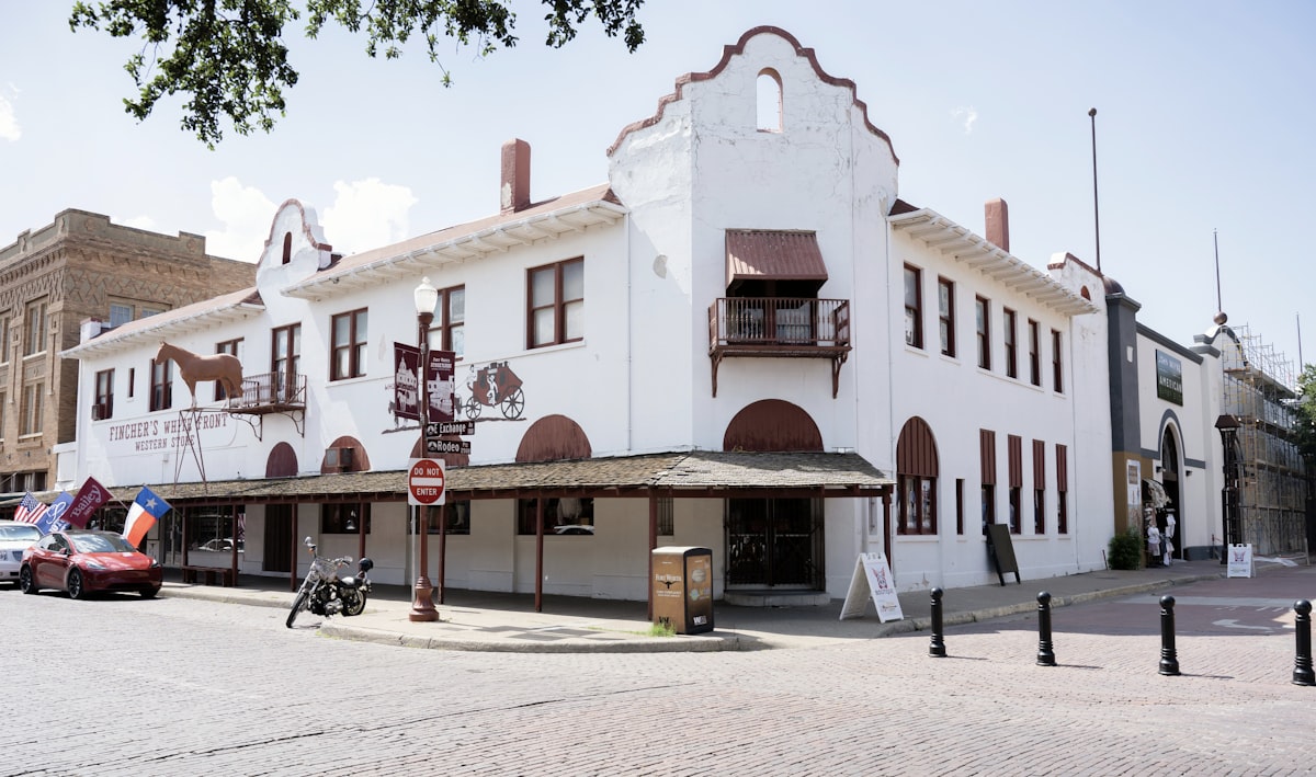a white building with red trim on a street corner