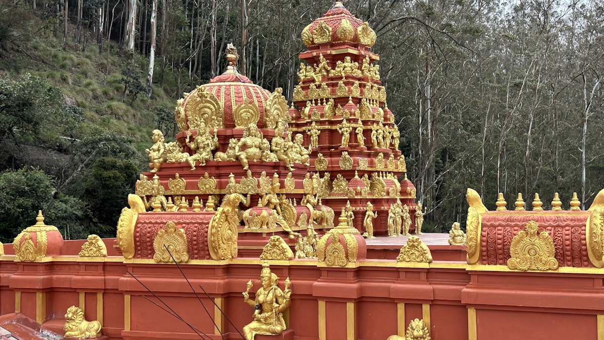 A large red and yellow structure with statues on it