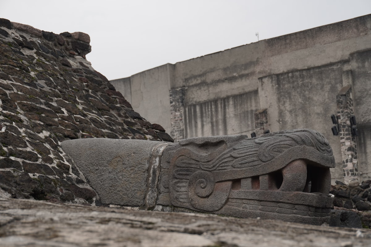 Stone serpent head sculpture at ancient ruins