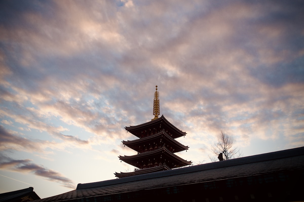 a tall building sitting under a cloudy sky