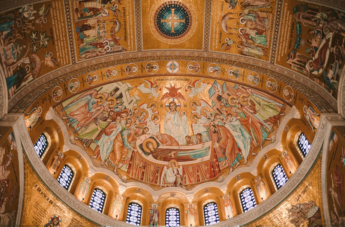 The ceiling of a building with a painting on it