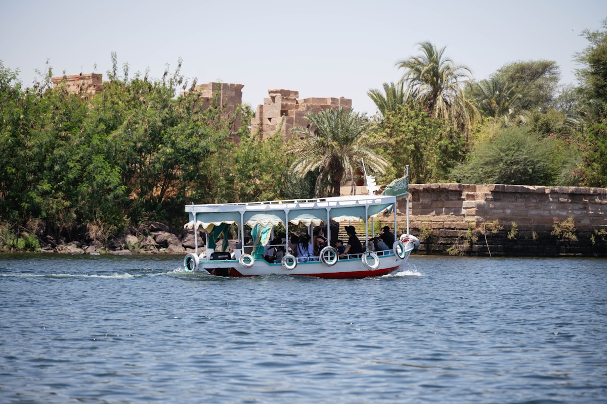 A boat sails down the river with tourists.
