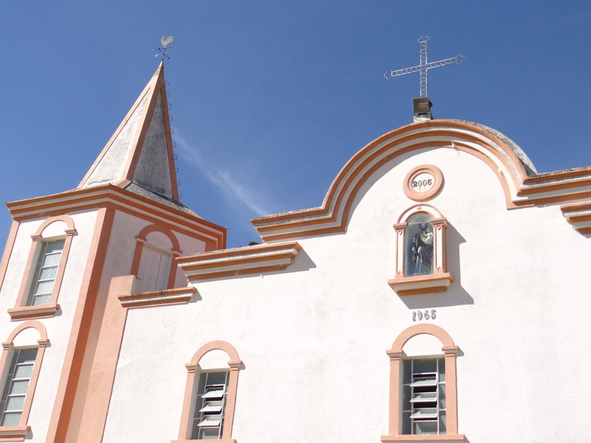 A white church building with a cross.